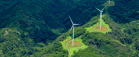 Rolling green hills with two wind turbines on them