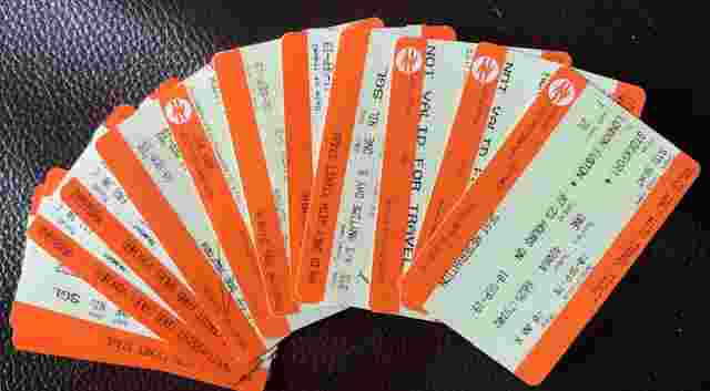 A stack of train tickets fanned out like playing cards. 