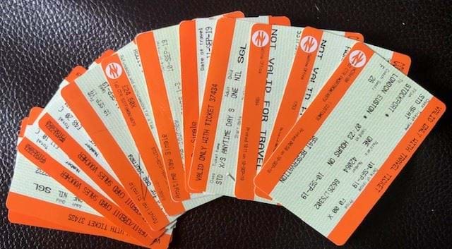 A stack of train tickets fanned out like playing cards.