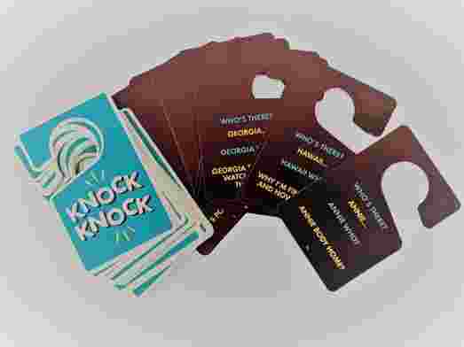 A stack of knock knock joke cards, fanned out displaying a few sample jokes. 