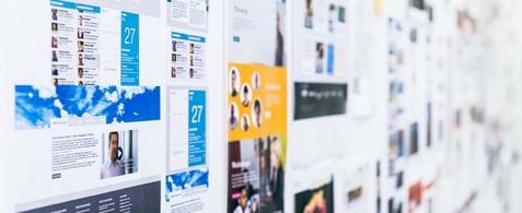 A wall with printed out screenshots of lots of websites.